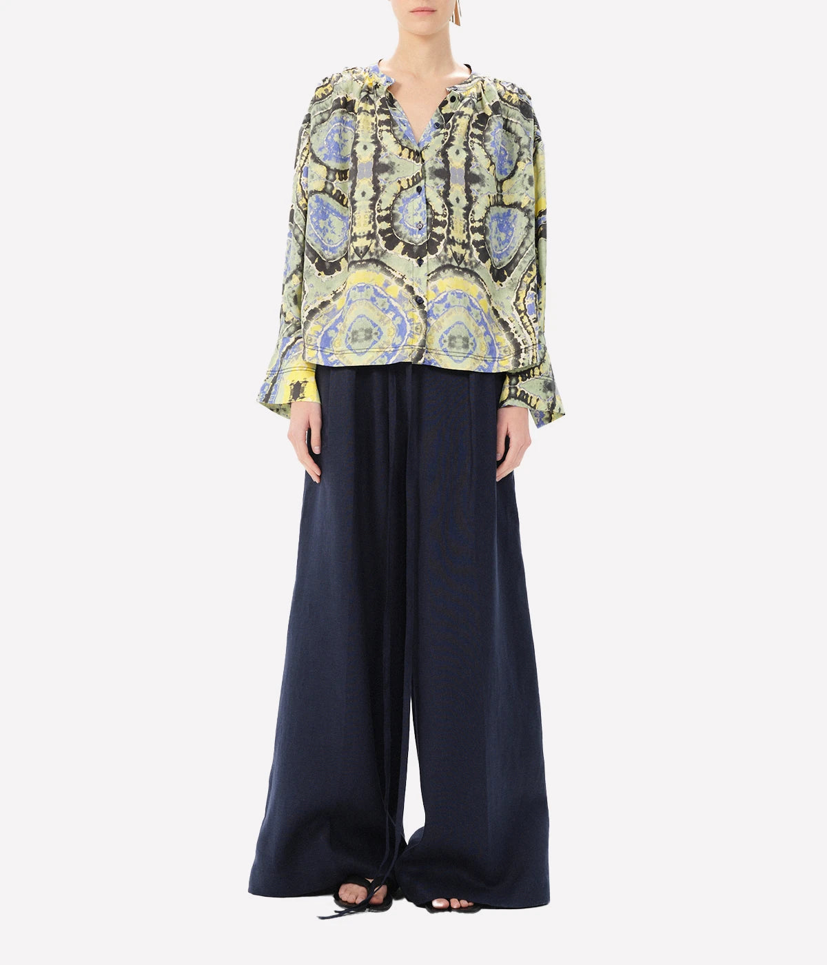 ALT text: Printed long-sleeve blouse with a deep V-neck tie and balloon sleeves.