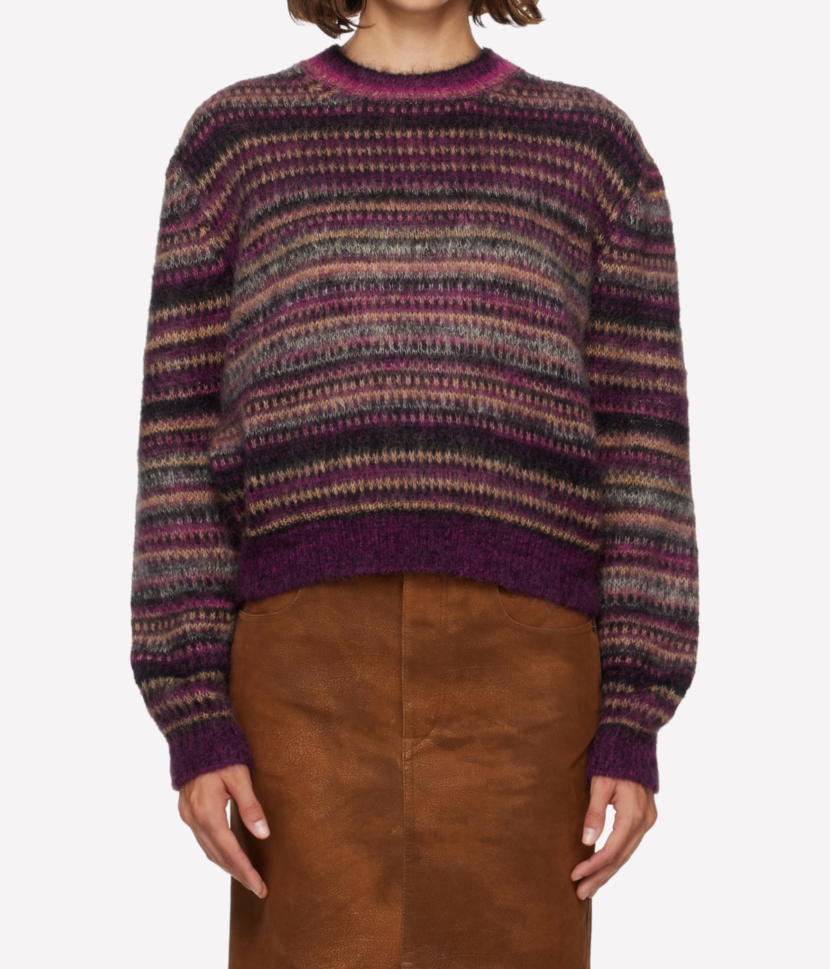 A person wearing a fuzzy knit crewneck sweater with horizontal multicolor stripes in purple, brown, gray, and beige, Isabel Marant Morine Mohair Sweater In Plum