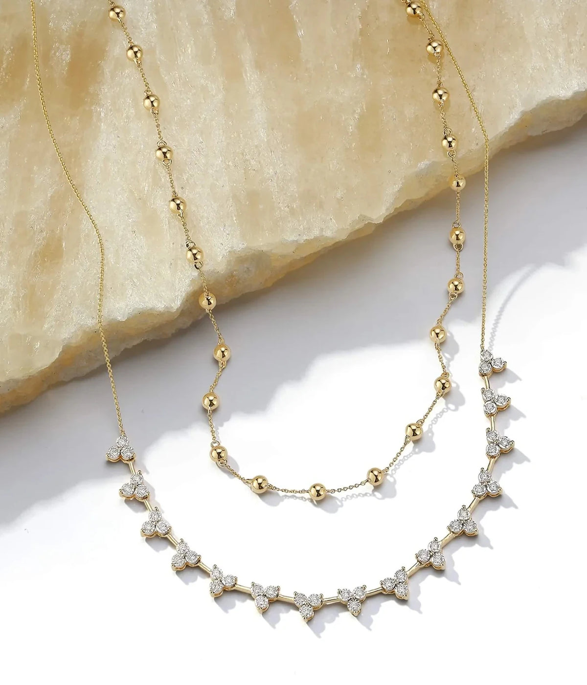 Dana Rebecca Designs Ava Bea Interval Trio Tennis Necklace in 14k Yellow Gold displayed with a second fine gold chain, showing how the two layer together