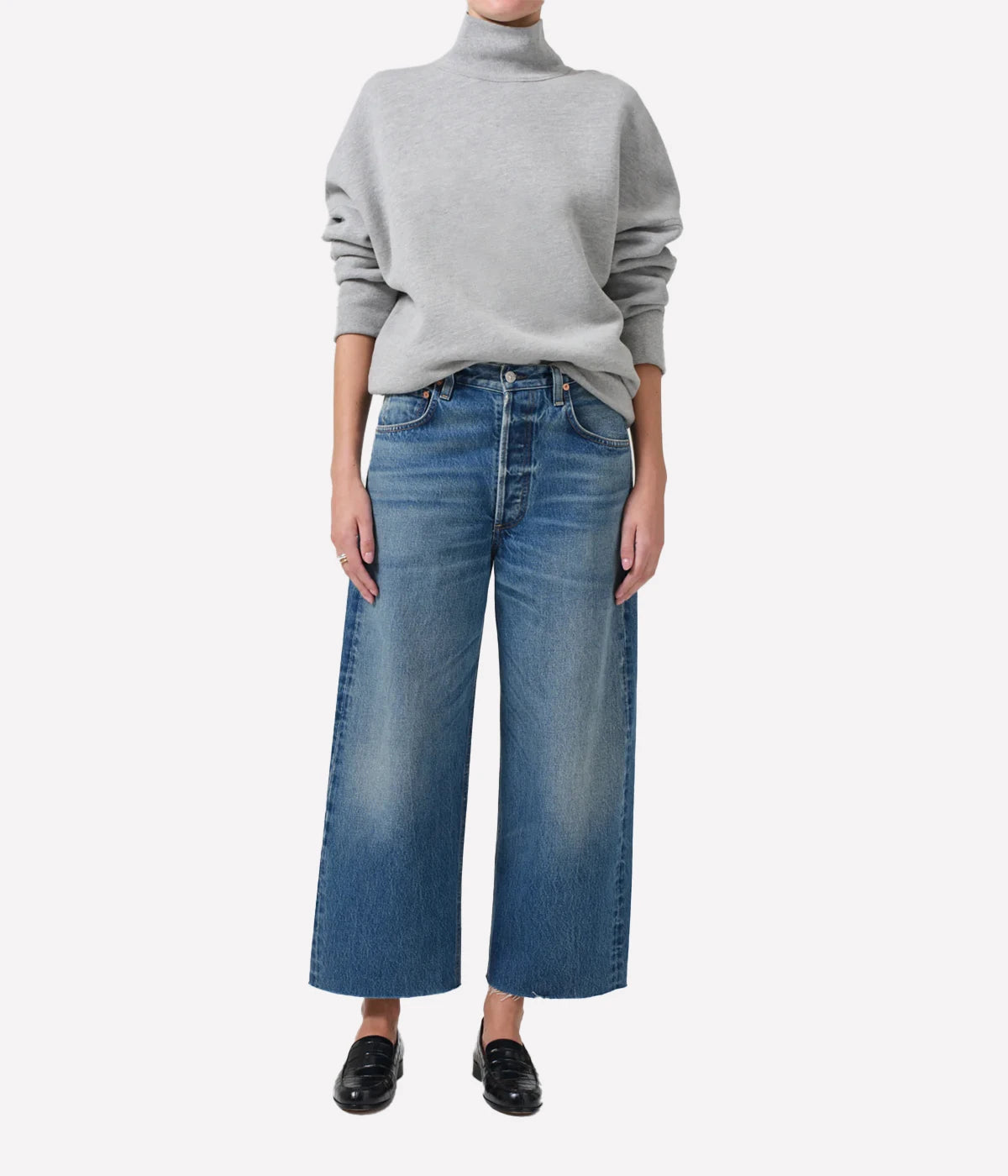 Ayla Raw Hem Crop Jean in medium indigo, featuring a relaxed rise, easy leg, and cropped inseam with fading and whiskering, crafted from 100% regenerative cotton.