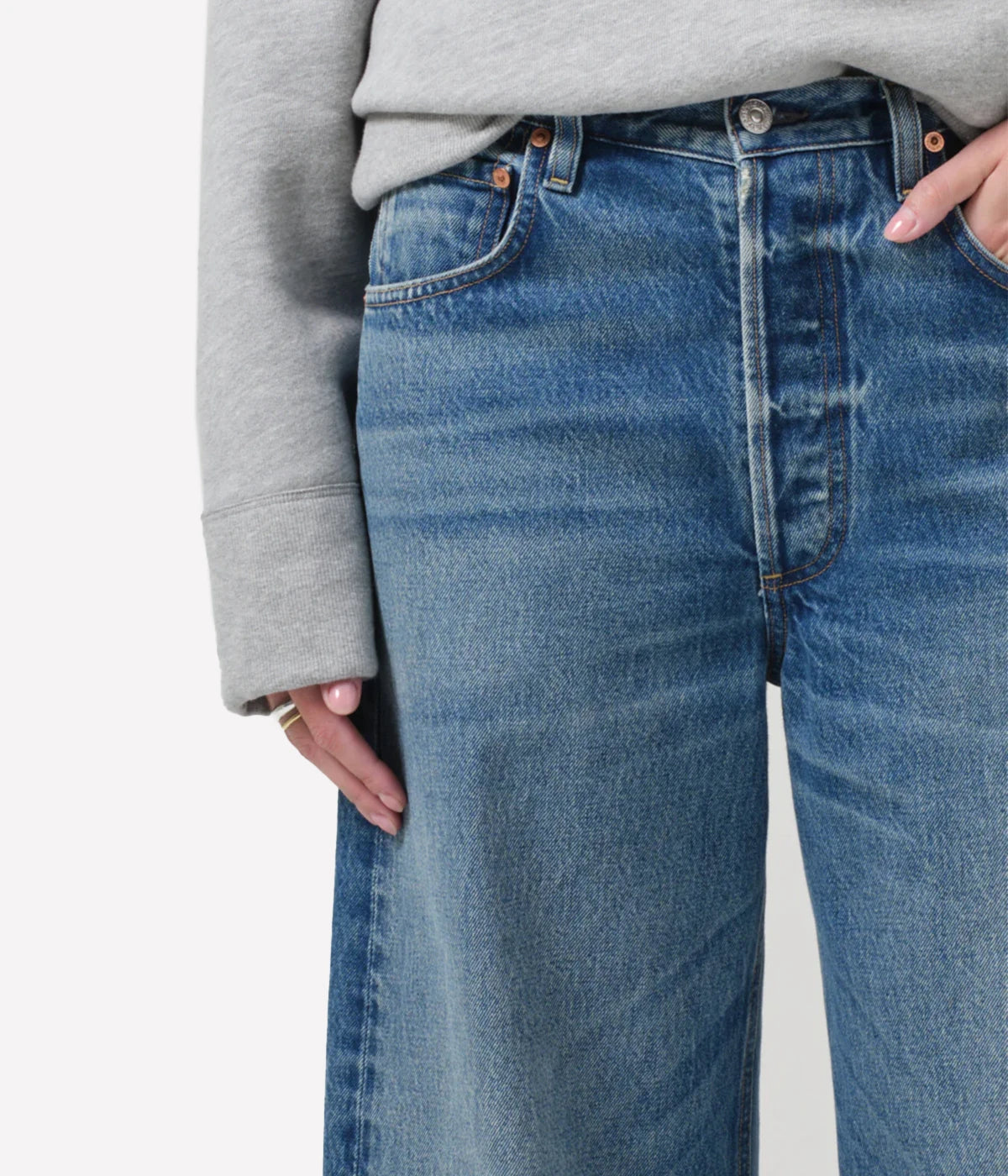 Ayla Raw Hem Crop Jean in medium indigo, featuring a relaxed rise, easy leg, and cropped inseam with fading and whiskering, crafted from 100% regenerative cotton.