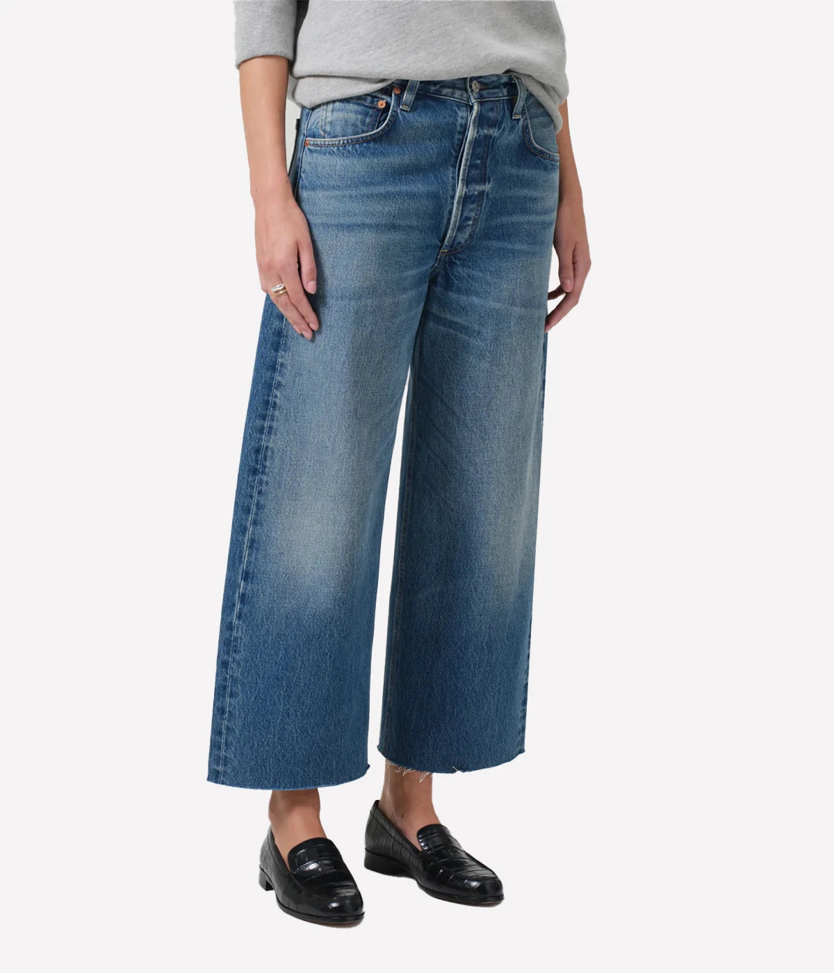 Ayla Raw Hem Crop Jean in medium indigo, featuring a relaxed rise, easy leg, and cropped inseam with fading and whiskering, crafted from 100% regenerative cotton.