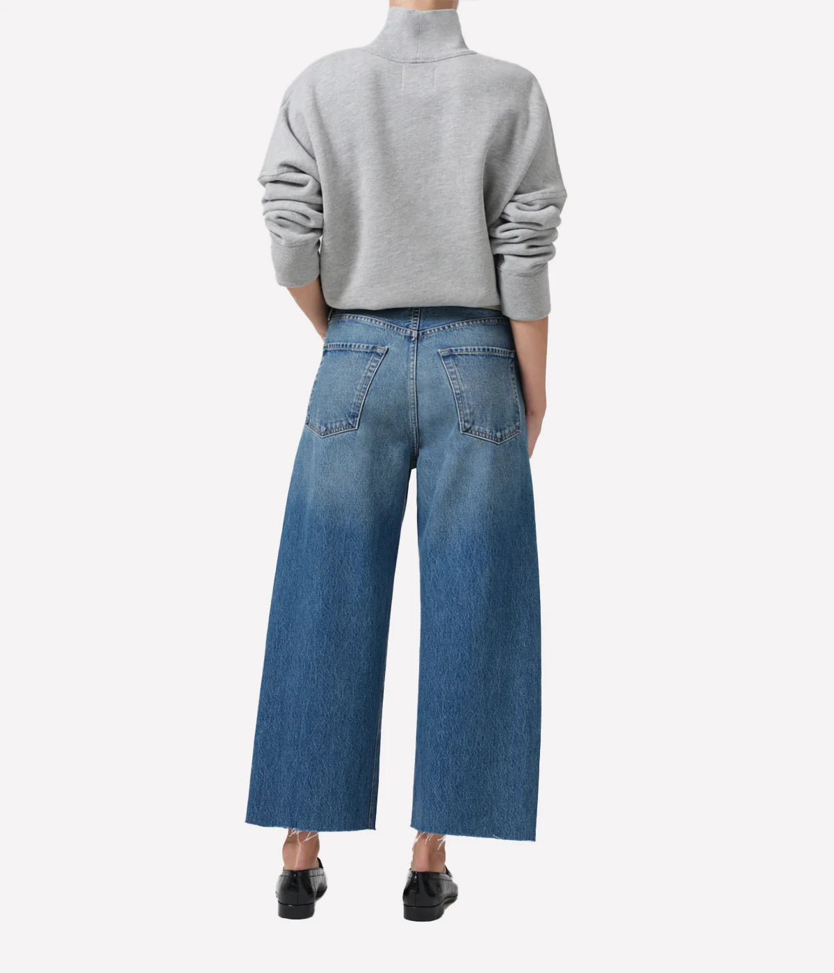 Ayla Raw Hem Crop Jean in medium indigo, featuring a relaxed rise, easy leg, and cropped inseam with fading and whiskering, crafted from 100% regenerative cotton.