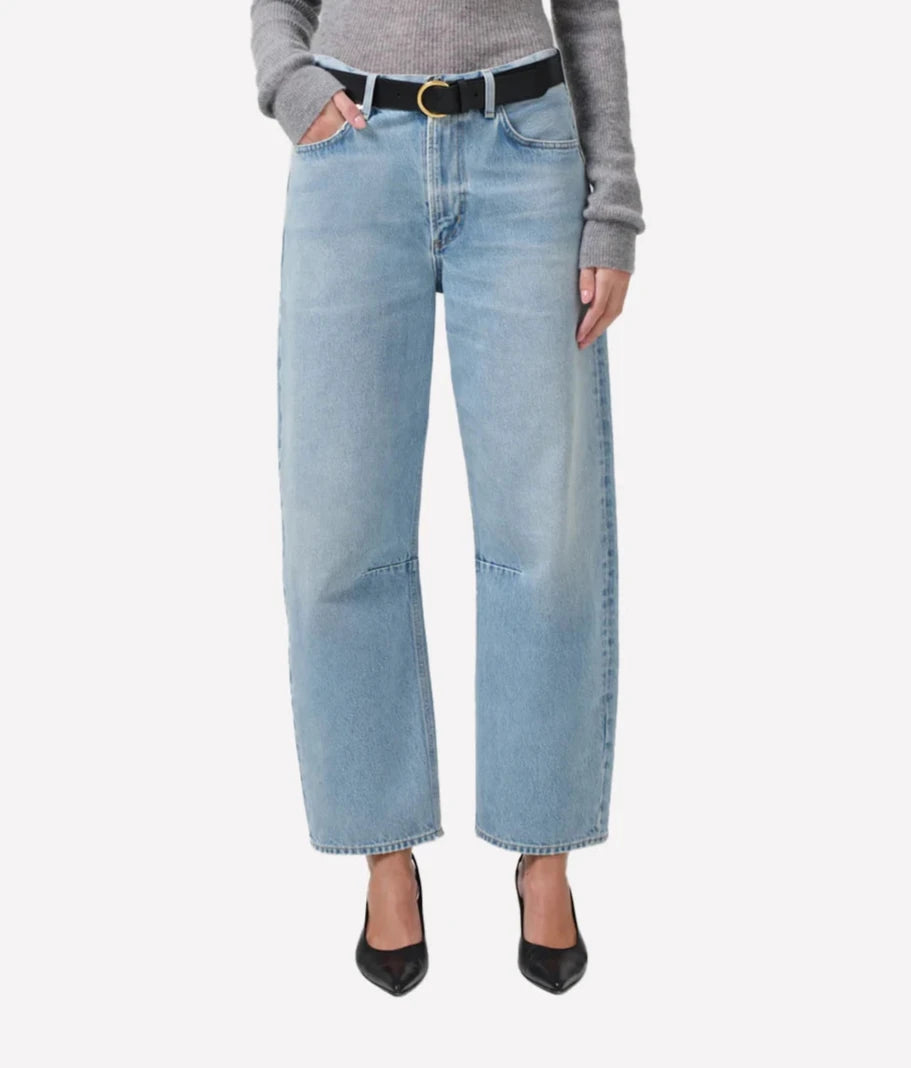 ALT Text: Light indigo tapered barrel-leg jeans with subtle fading, rigid cotton fabric, and a relaxed fit through the top block.