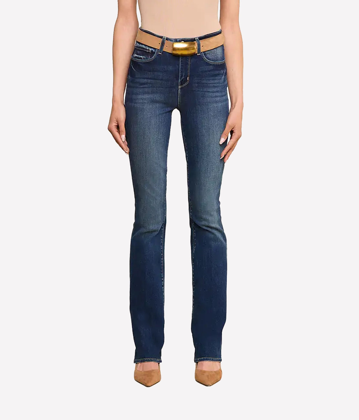 A model wearing a pair of dark blue jeans with a tan belt and gold buckle, shown from the waist down.