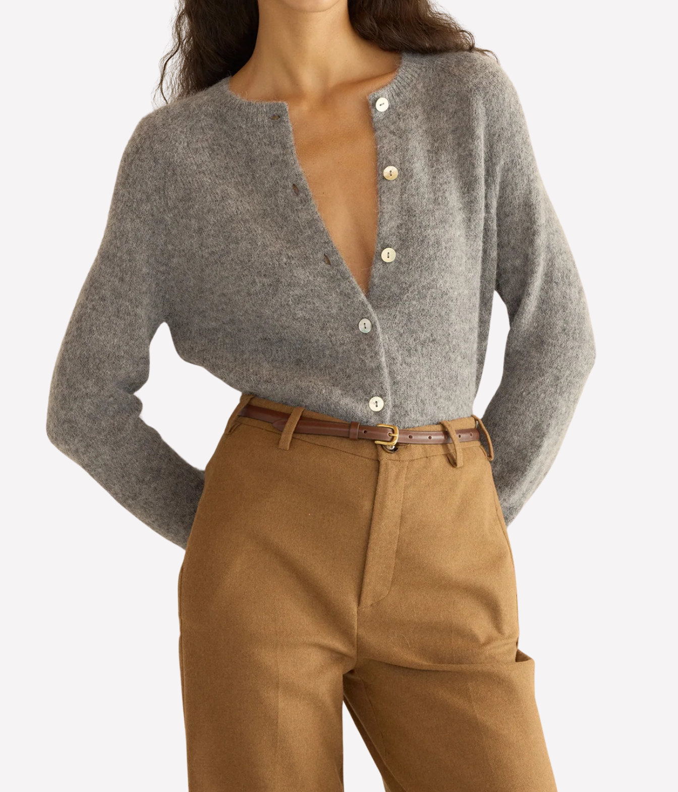 A woman wearing a grey knit cardigan with front buttons front view