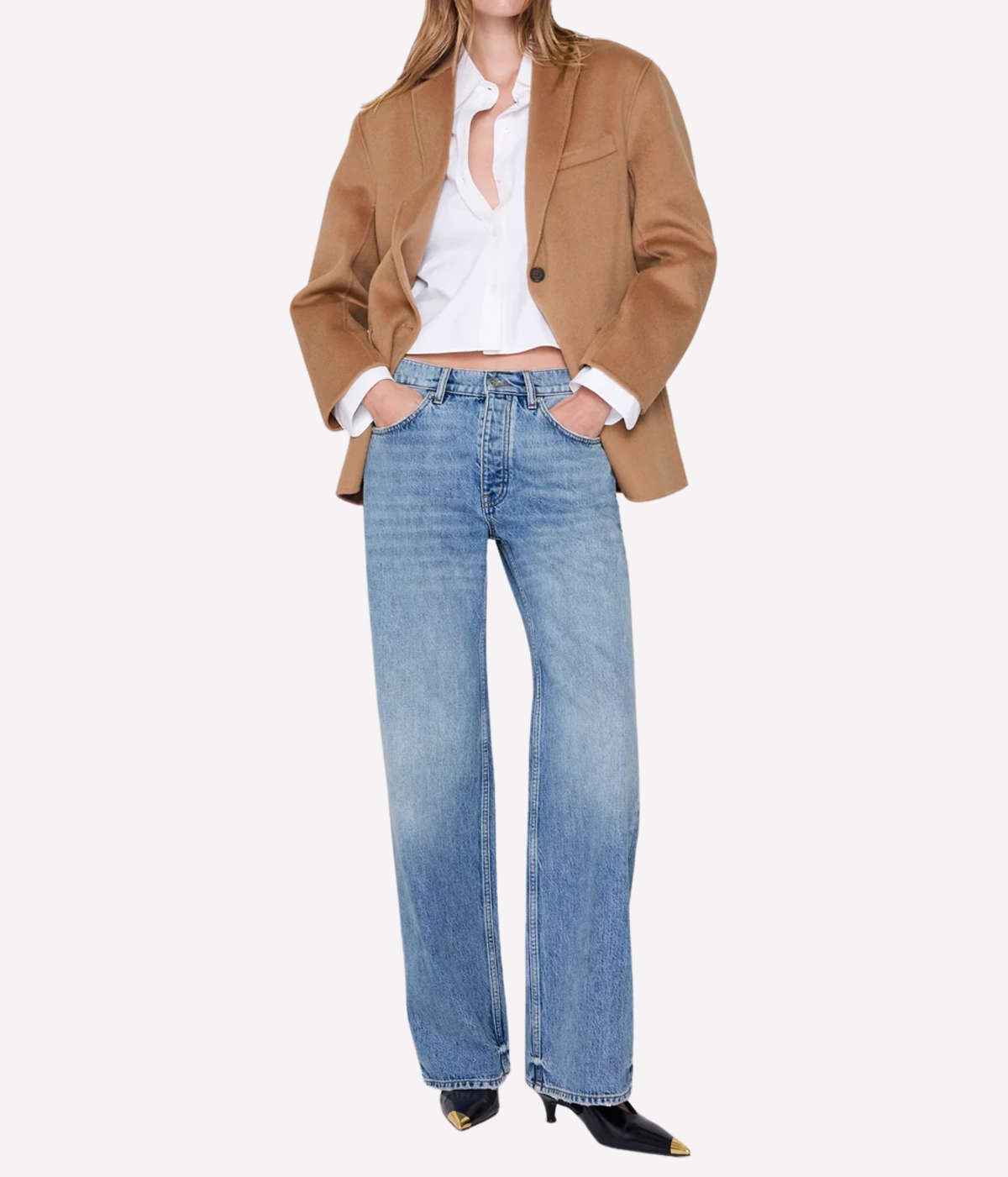 A model wearing a camel brown blazer, white button-down shirt, and light-wash blue wide-leg jeans, paired with black pointed-toe heels, against a plain white background.