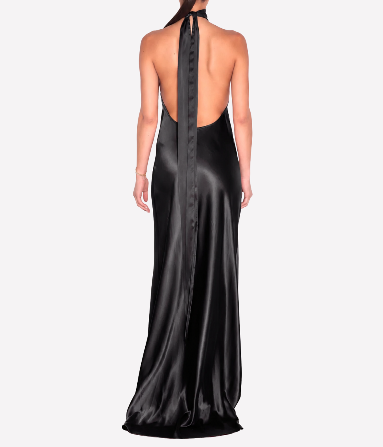 A woman shown from the back wearing a floor-length black satin gown with a high open back, tie neckline, and long draped train against a light gray studio background.