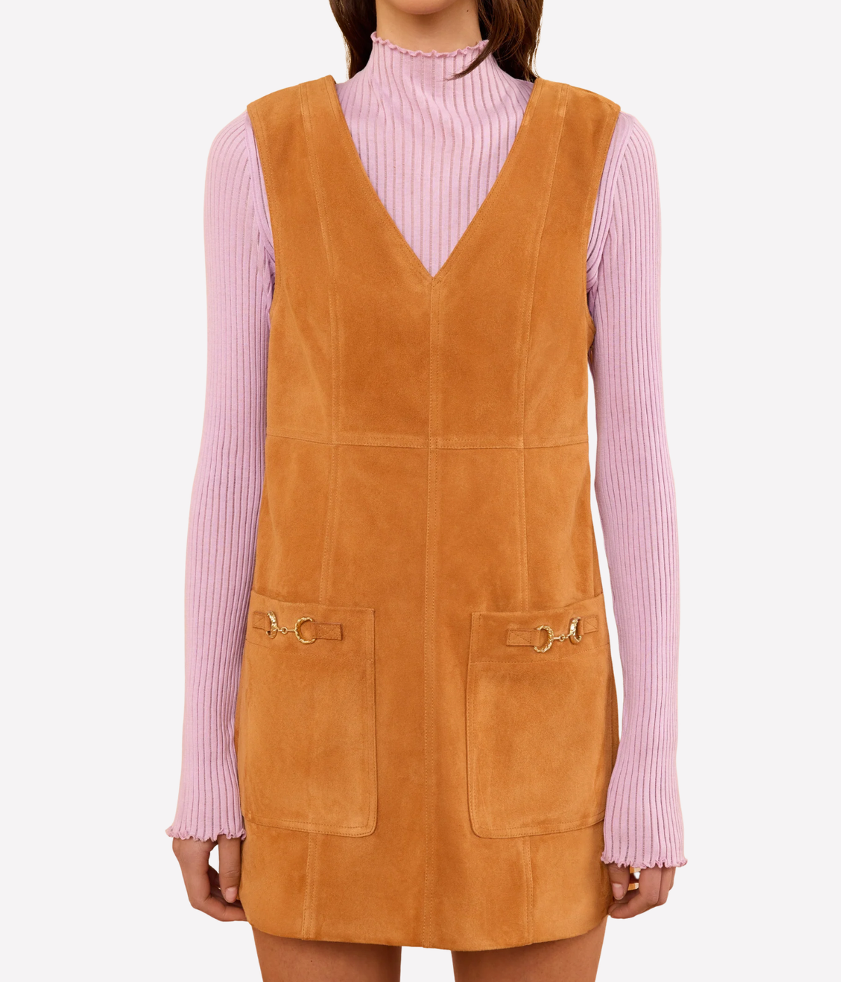 Ulla Johnson Sloane Suede Mini Dress in Cognac brown, front view on a model layered over a pink ribbed knit top.