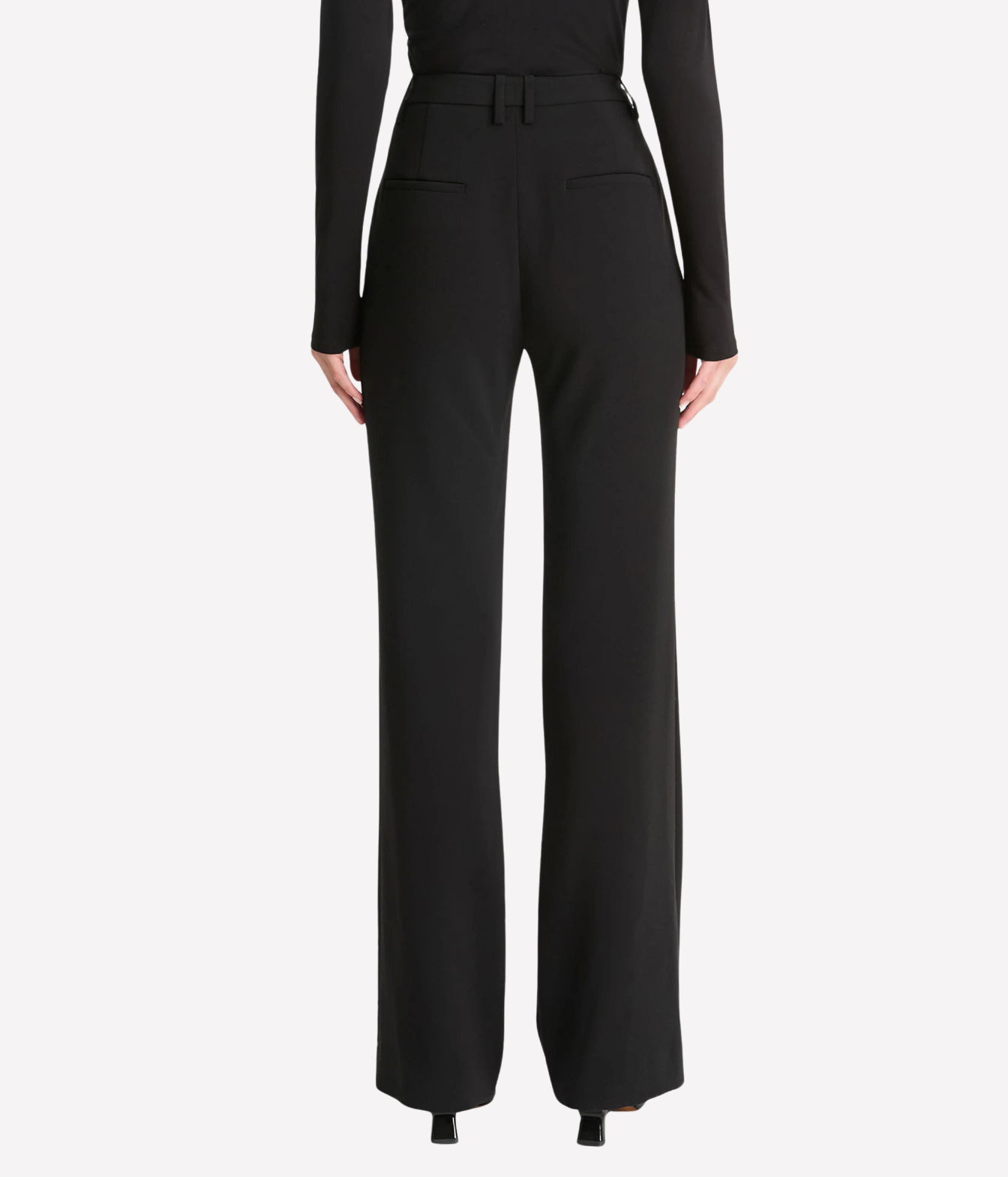A model from the back wearing black wide-leg trousers with a matching belt, shown against a plain white studio background.