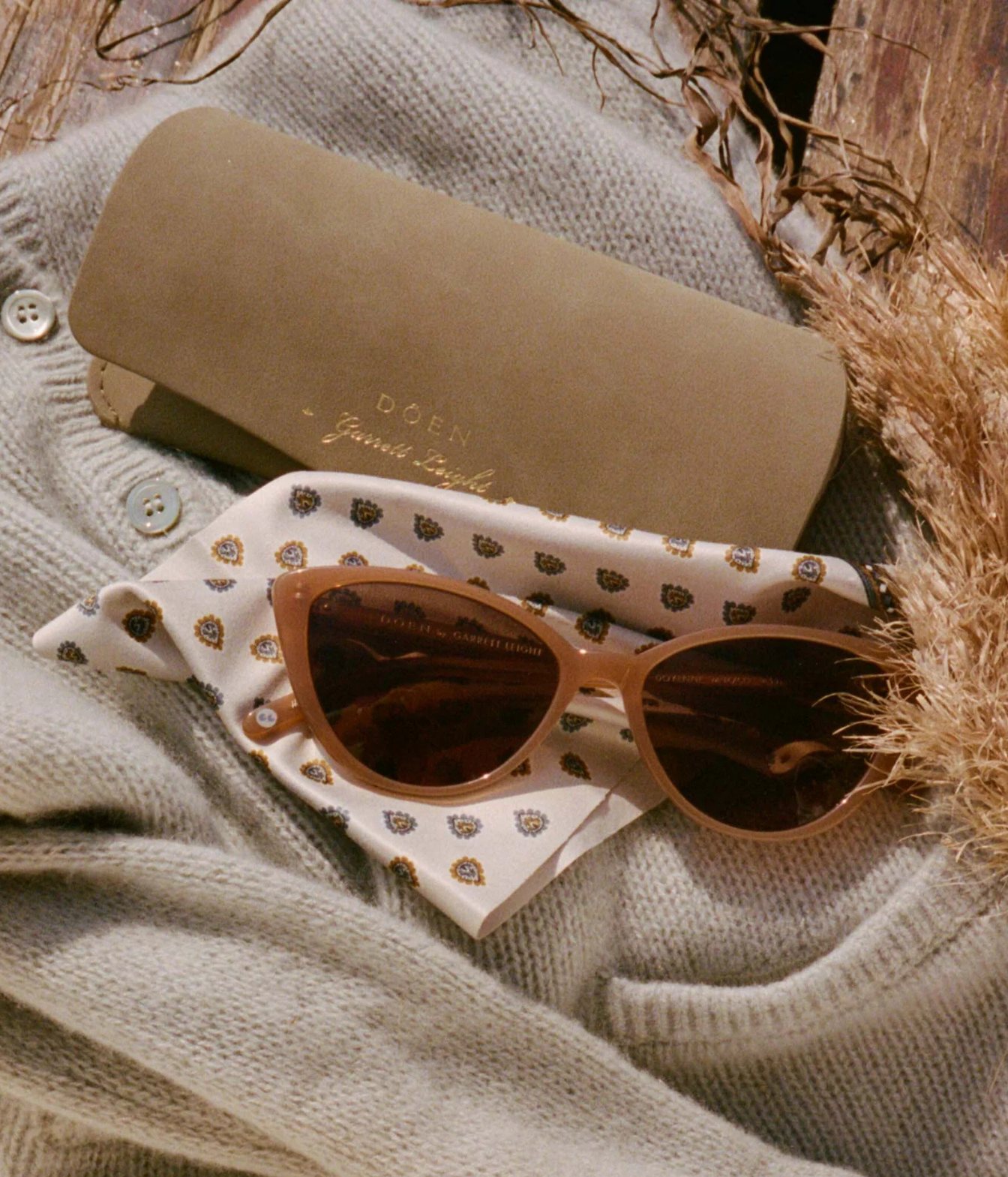 Cat-eye sunglasses with brown frames and dark lenses