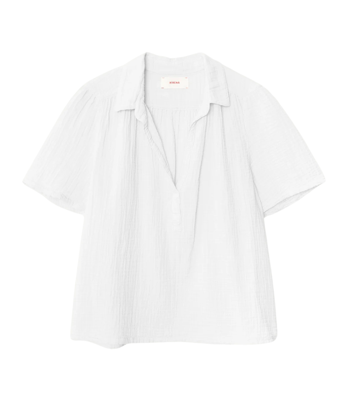 Xirena Rylee Top in Pale Sky laid flat, showing the spread collar, open placket and short sleeves with subtle shirring at the yoke