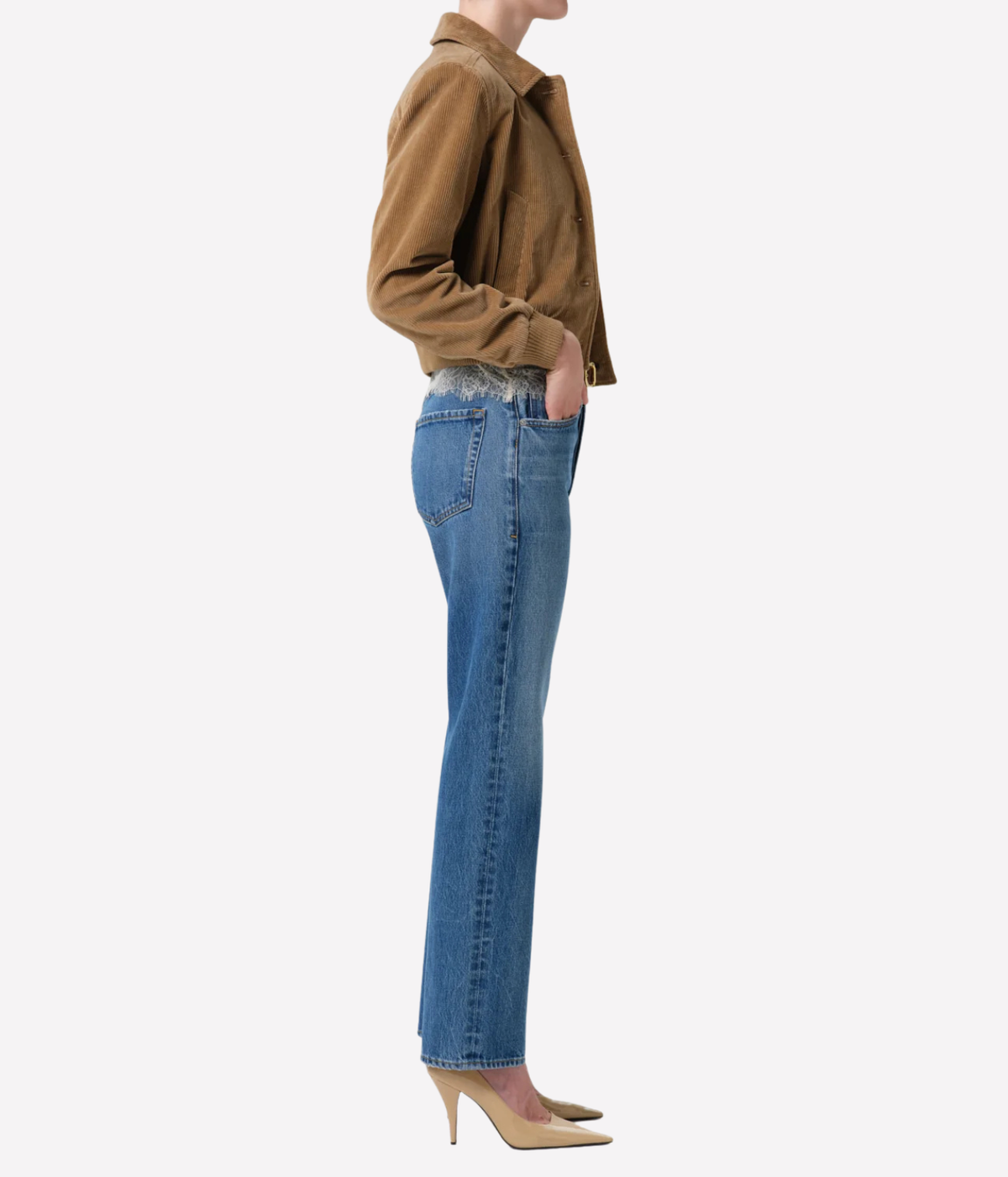Side profile of a model wearing the Citizens of Humanity 90s French Straight in Pastis with a hand in the back pocket, a tan cropped jacket and nude heels, showing the high rise and straight leg