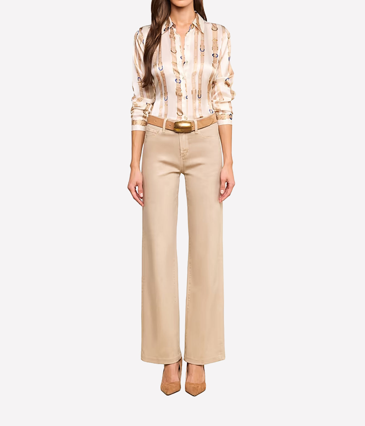 A model wearing a beige and cream striped silk shirt with a small blue and gold pattern, paired with beige wide-leg trousers, a tan belt, and tan pointed-toe heels.