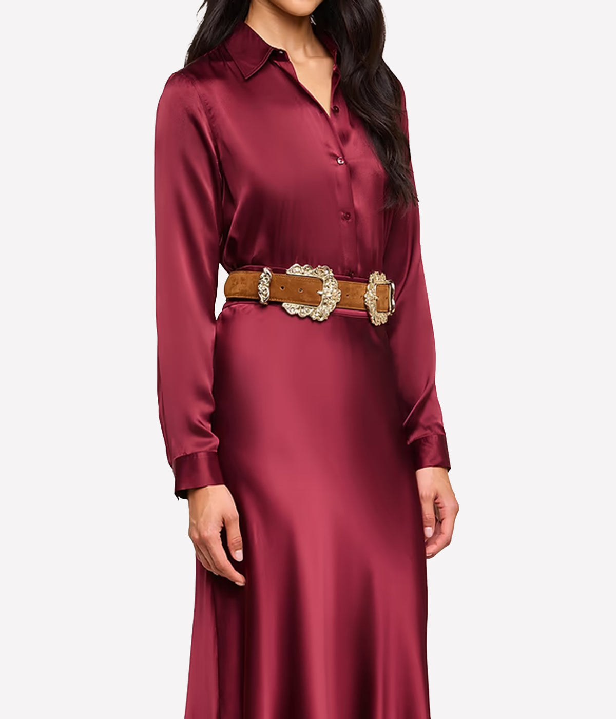 A front side on image woman wearing the L'AGENCE Tyler Silk Blouse in Merlot Red, styled with a brown suede belt and matching silk maxi skirt in red