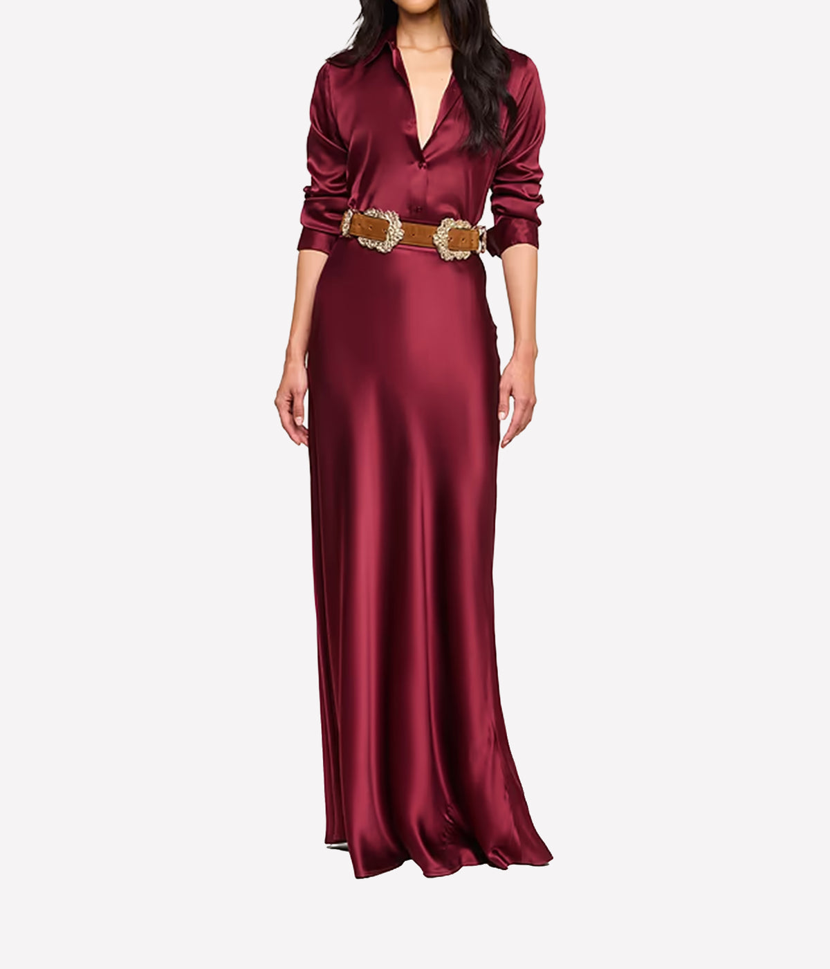 A woman wearing the L'AGENCE Tyler Silk Blouse in Merlot Red, styled with a brown suede belt and matching silk maxi skirt in red