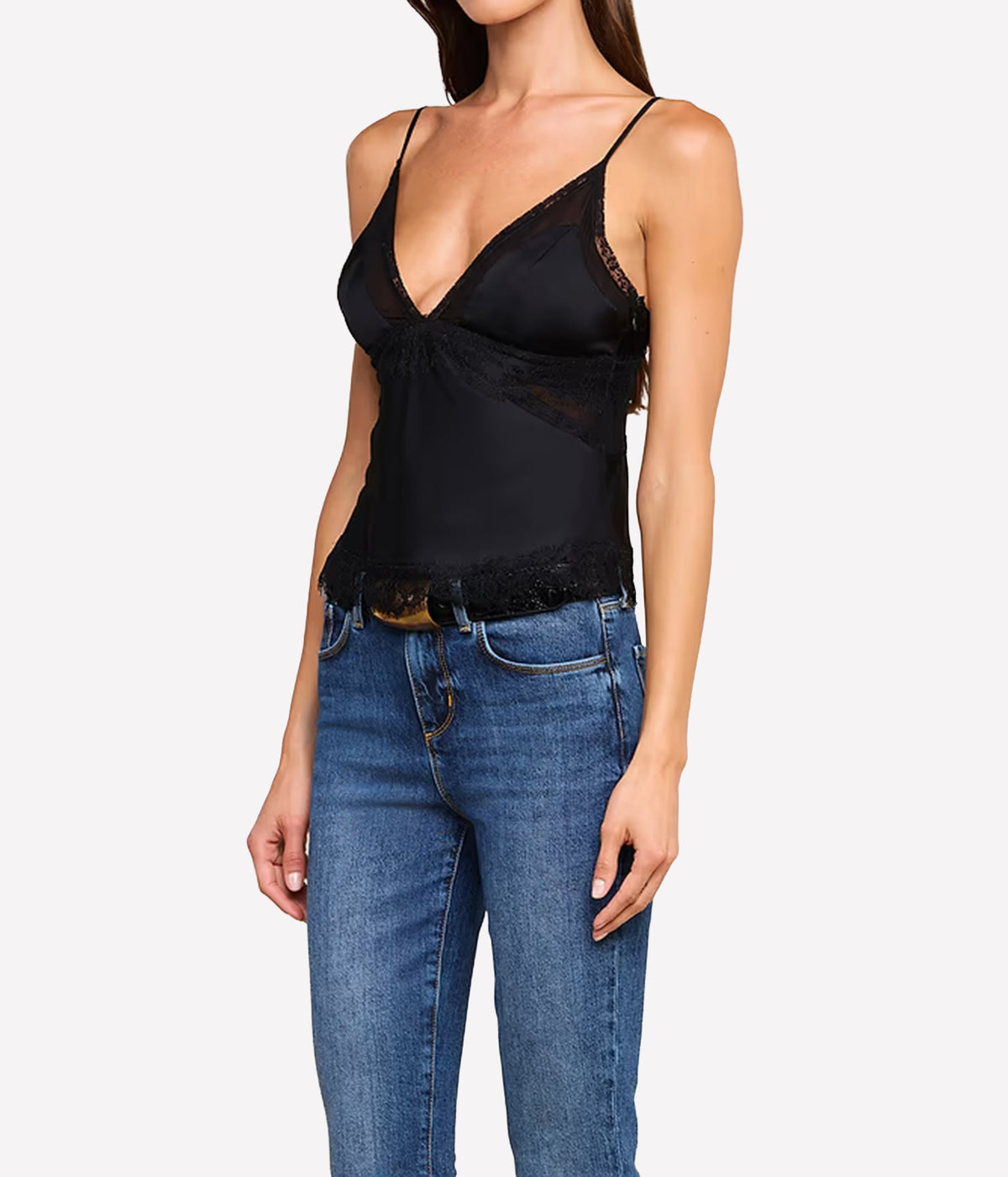 A woman wearing the L'AGENCE Elka Satin Lace Camisole in Black with blue jeans, shown from the neck down.