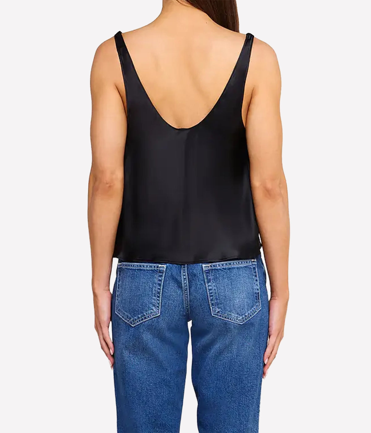 A woman shown from the back wearing the L'AGENCE Evadne Silk Lace Camisole in Black with a deep V-neck and wide straps, paired with blue jeans.