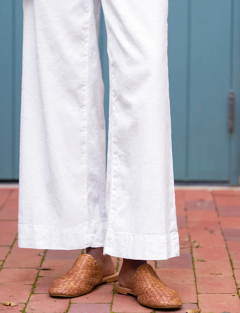ALT Text: High-rise wide-leg trousers in Italian Performance Linen with a cropped clean hem and back patch pockets for a sleek and flattering look.