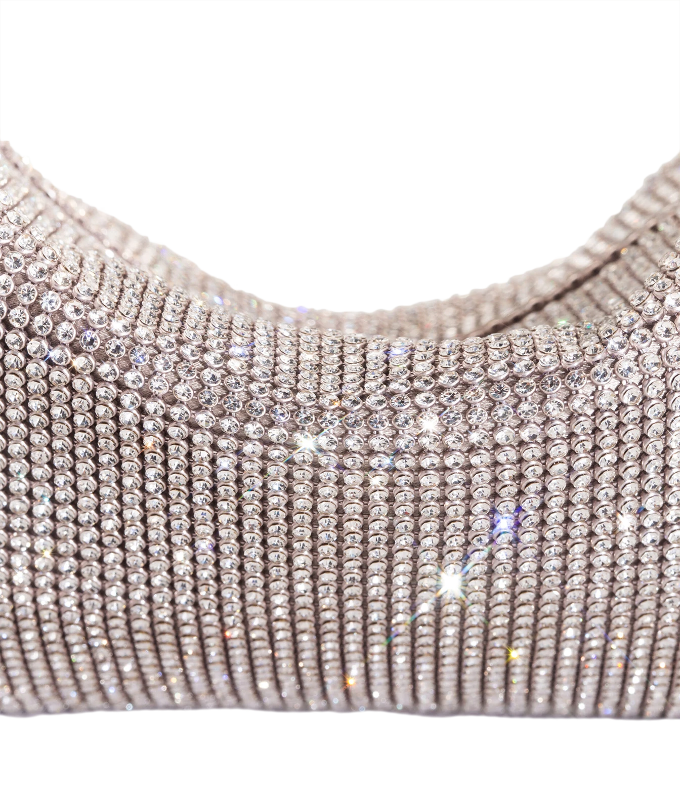 A close-up of a metallic silver rhinestone-covered garment, showing rows of sparkling clear stones on a white background.