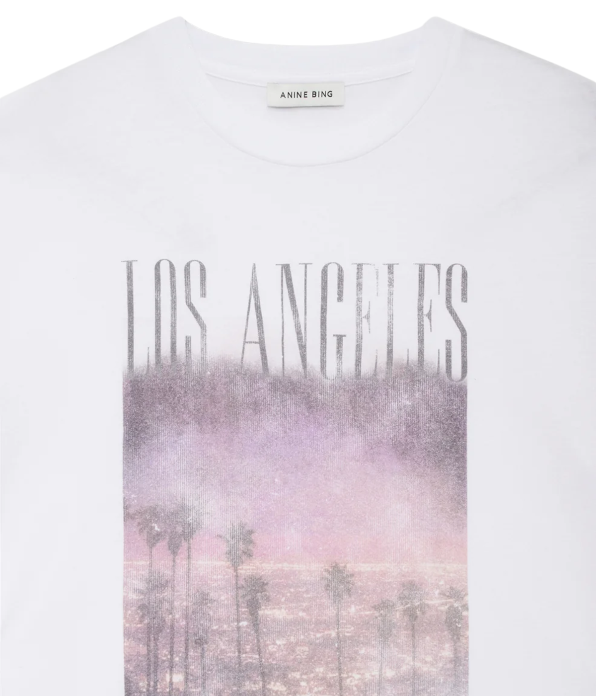 Close-up of the Anine Bing Cade Tee Los Angeles In White showing the crew neckline and the faded LOS ANGELES graphic over a pastel palm tree print