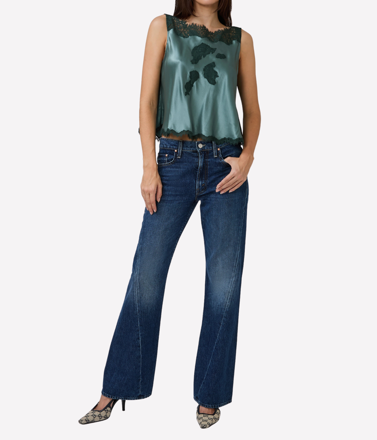 brunette model wearing Valerina Top in Dulac Green by doen - green blouse top with lace green detailing