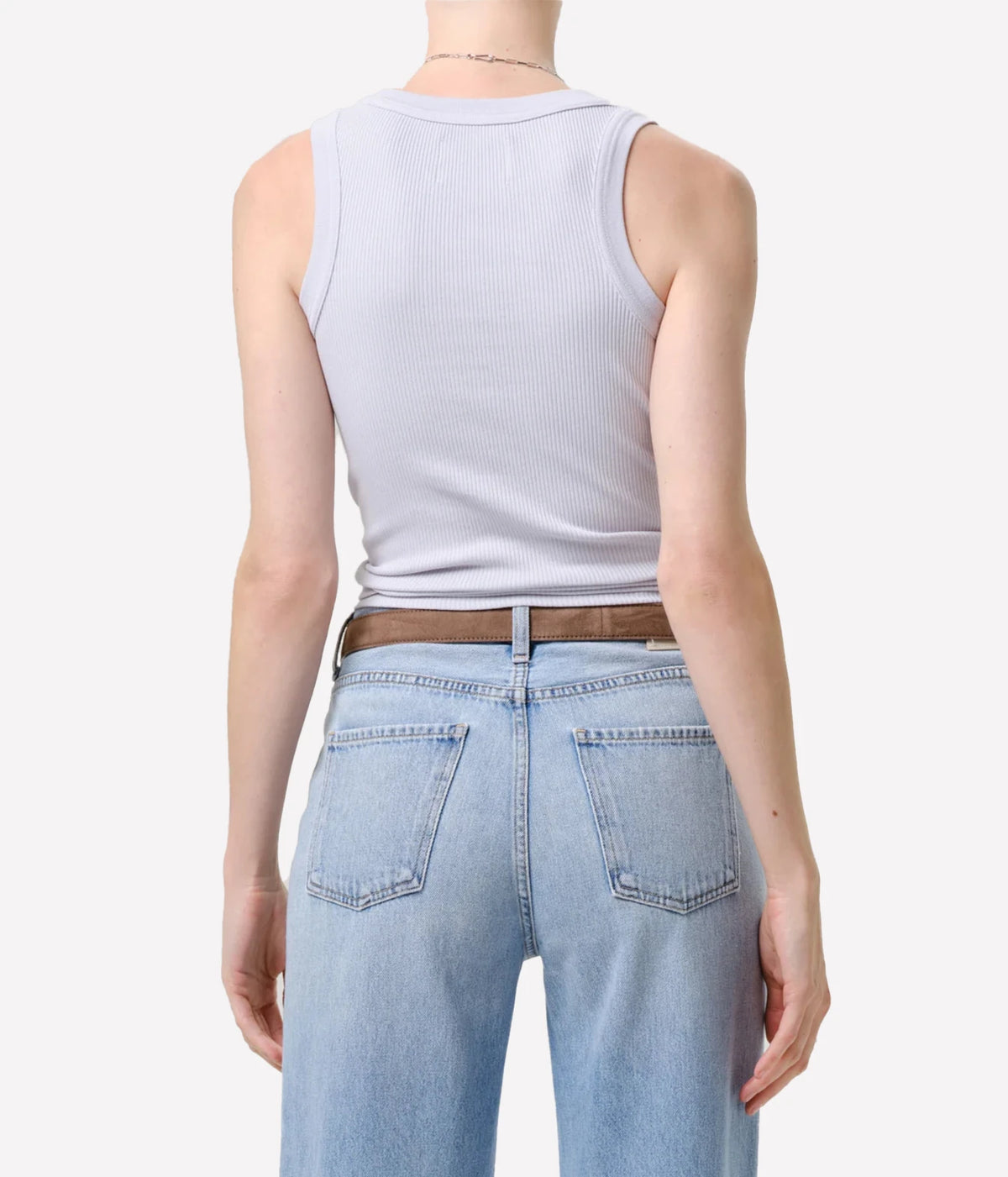 Back view of a model wearing the Citizens Of Humanity Isabel Rib Tank in Pindary with light-wash jeans and a brown leather belt, showing the fitted back and cropped hem