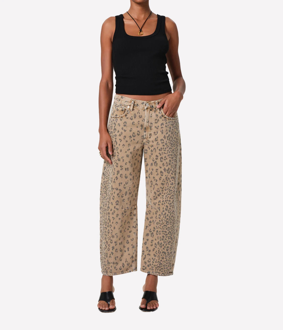 ALT text: Light beige denim jeans with cheetah print, styled with a simple tee.