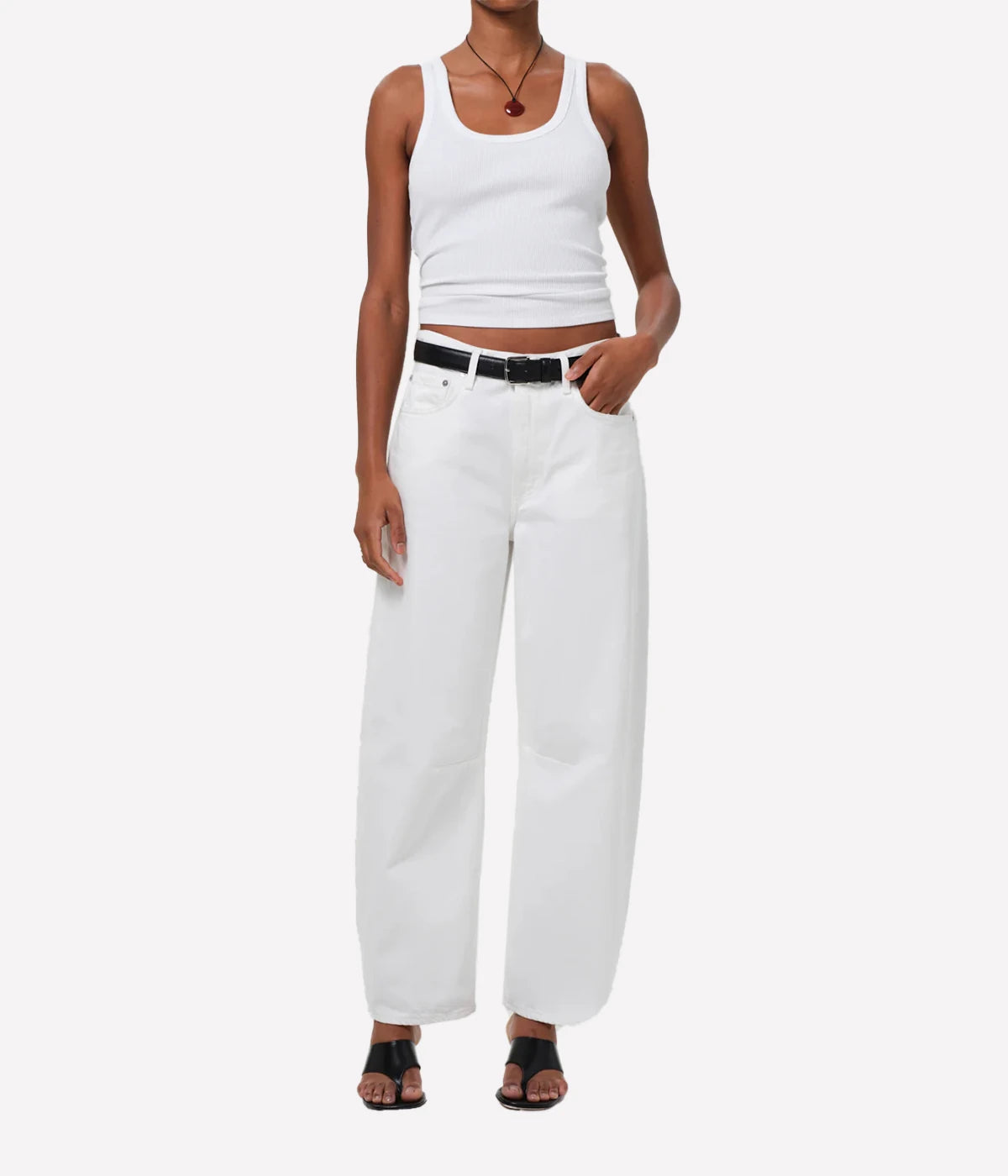 ALT text: White scoop neck ribbed tank top, styled with high-waisted jeans.