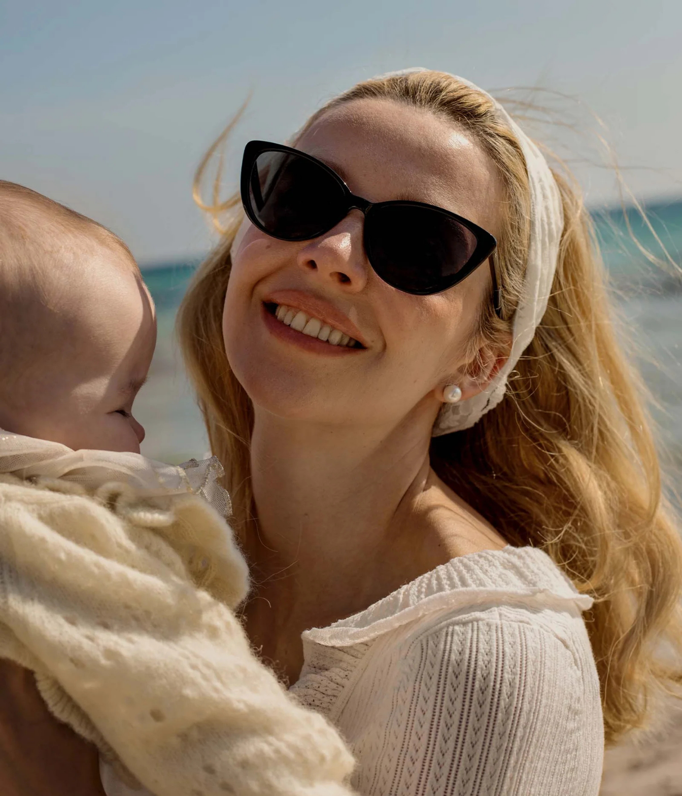 A woman wearing black cat-eye sunglasses Doen X Garrett Leight