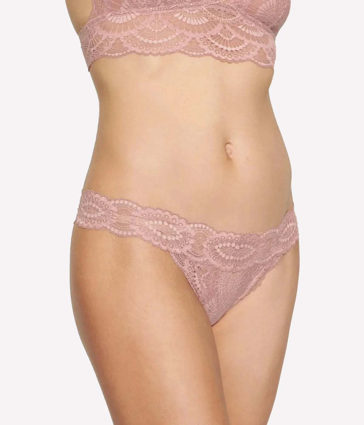 Model wearing the Eberjey Mariana Thong in Woodrose, front view showing the scalloped lace waistband, worn with the matching lace bralette