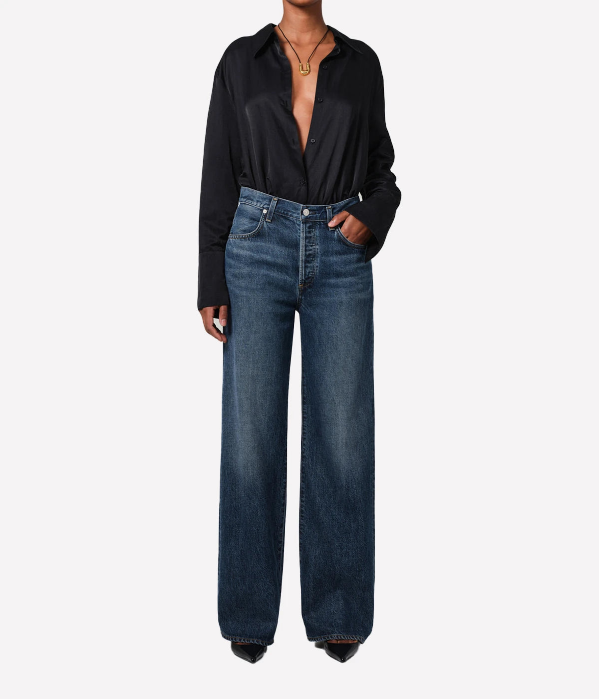 Neutral-toned high-rise cropped straight-leg jeans styled with a blouse and boots for a casual, yet polished look.