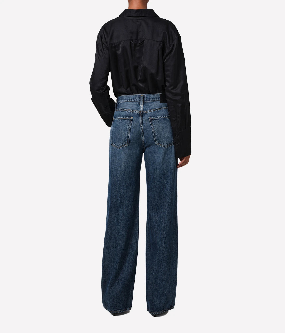 Neutral-toned high-rise cropped straight-leg jeans styled with a blouse and boots for a casual, yet polished look.