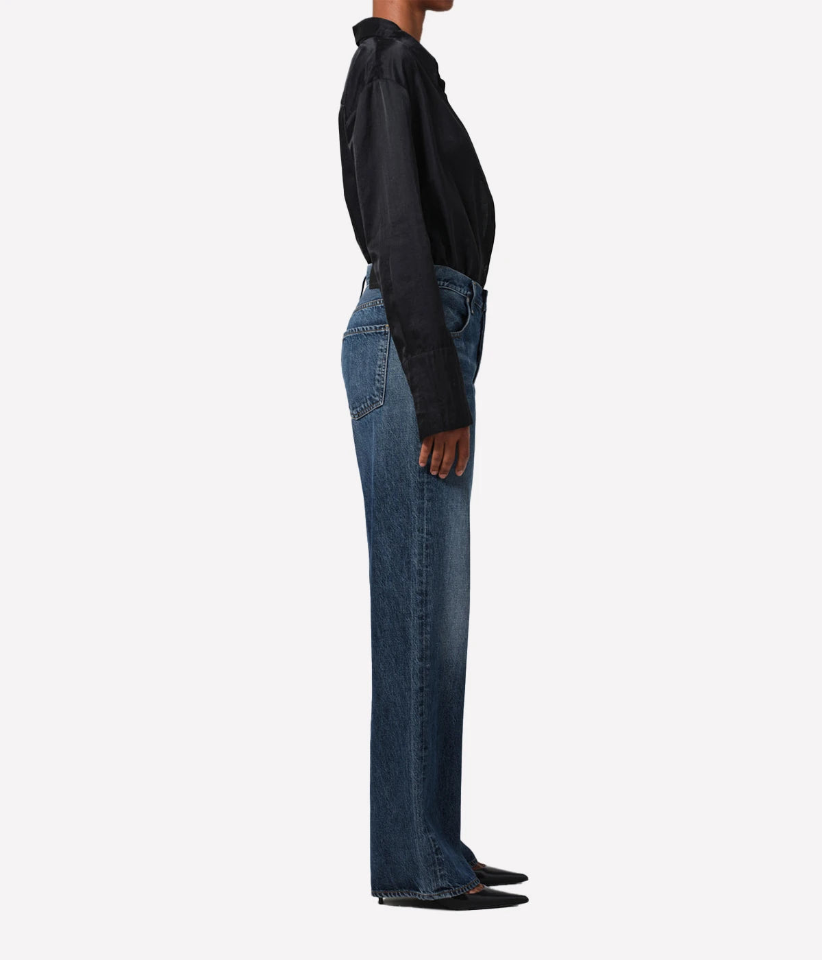 Neutral-toned high-rise cropped straight-leg jeans styled with a blouse and boots for a casual, yet polished look.