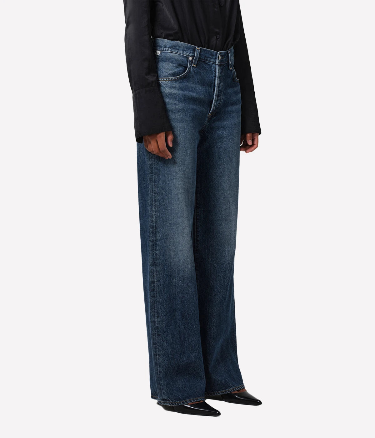 Neutral-toned high-rise cropped straight-leg jeans styled with a blouse and boots for a casual, yet polished look.