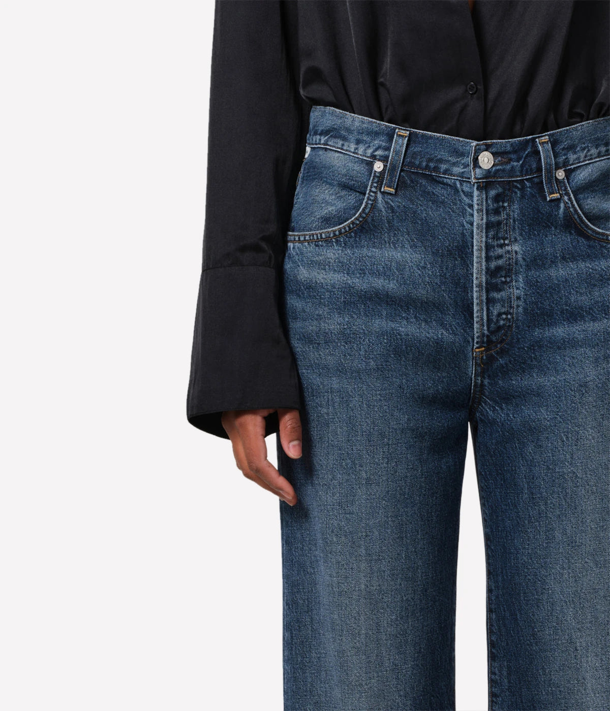 Neutral-toned high-rise cropped straight-leg jeans styled with a blouse and boots for a casual, yet polished look.