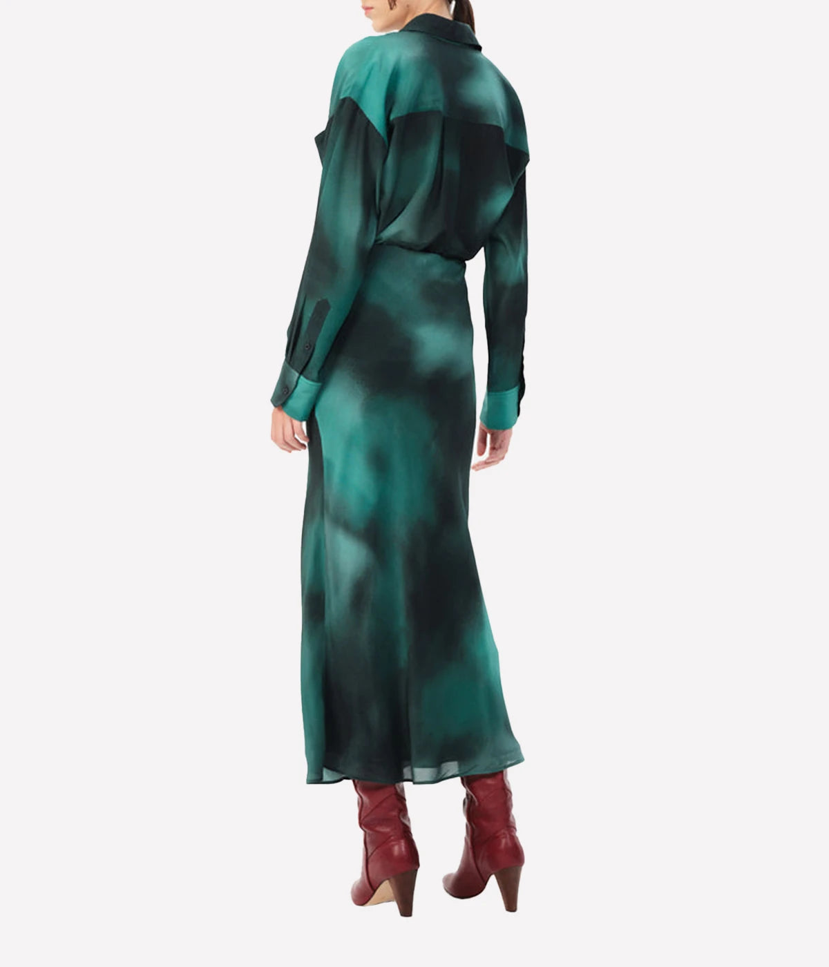 A flowing 100% silk midi skirt in a vibrant, refined hue, styled with a cashmere sweater and ankle boots for a chic look.