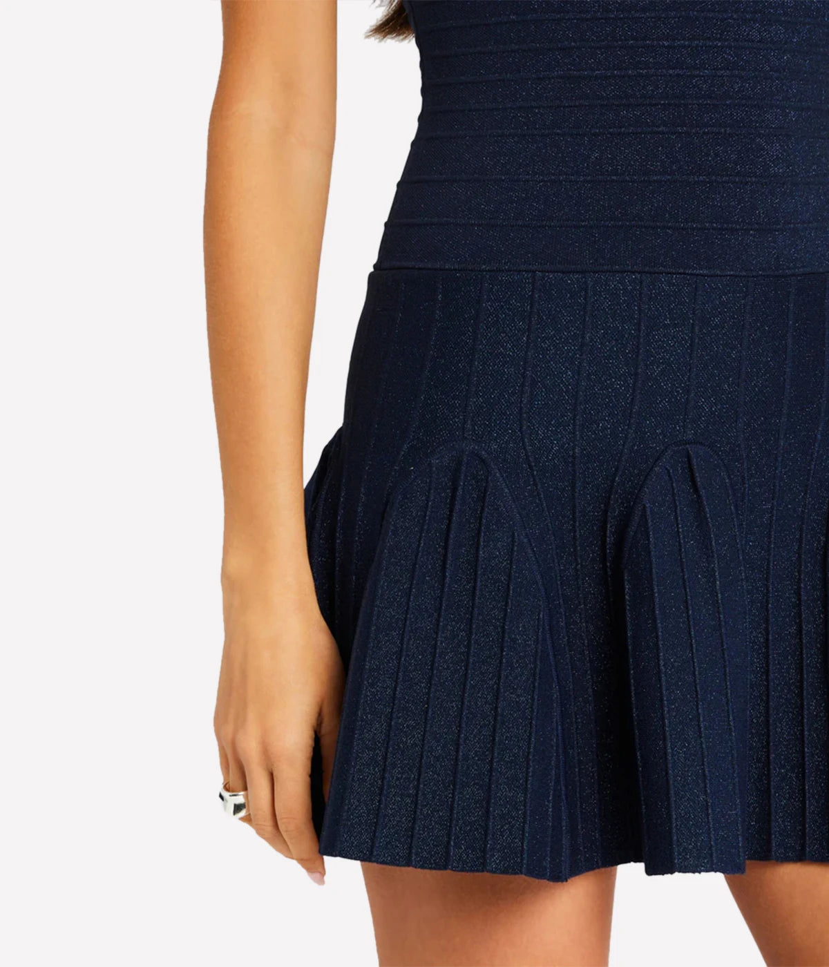 A sleeveless navy fit-and-flare knit dress with a metallic finish, styled for an elegant evening look.