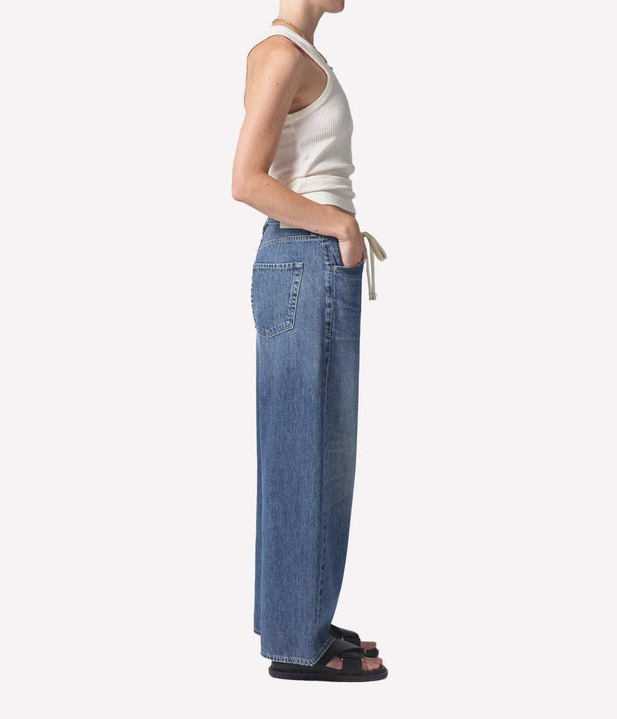 ALT Text: Brynn Jean in lightweight denim, featuring a wide leg, drawstring waist, and full-length inseam, made from 100% organic cotton for a relaxed yet sophisticated look.