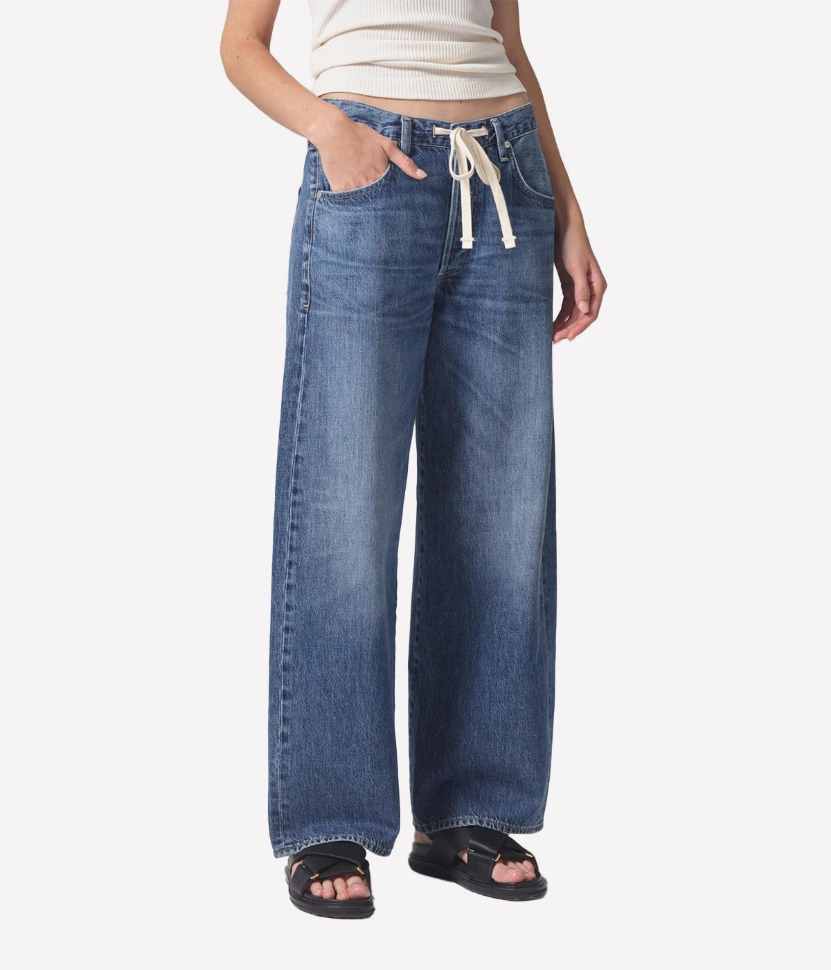ALT Text: Brynn Jean in lightweight denim, featuring a wide leg, drawstring waist, and full-length inseam, made from 100% organic cotton for a relaxed yet sophisticated look.