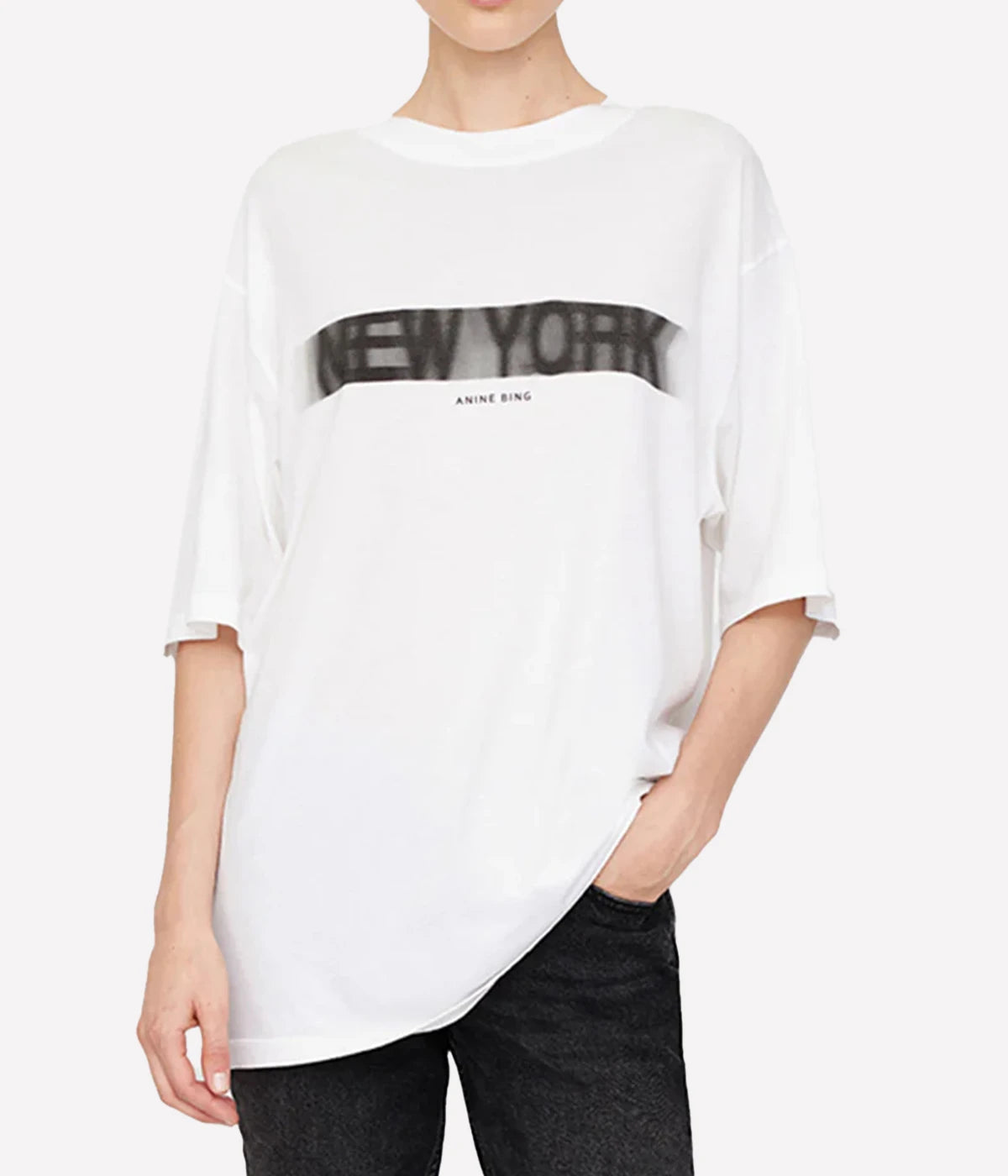 ALT text: Cason Tee Graffiti in ivory with a striking 'New York' graphic printed in rusted iron on the front and back.