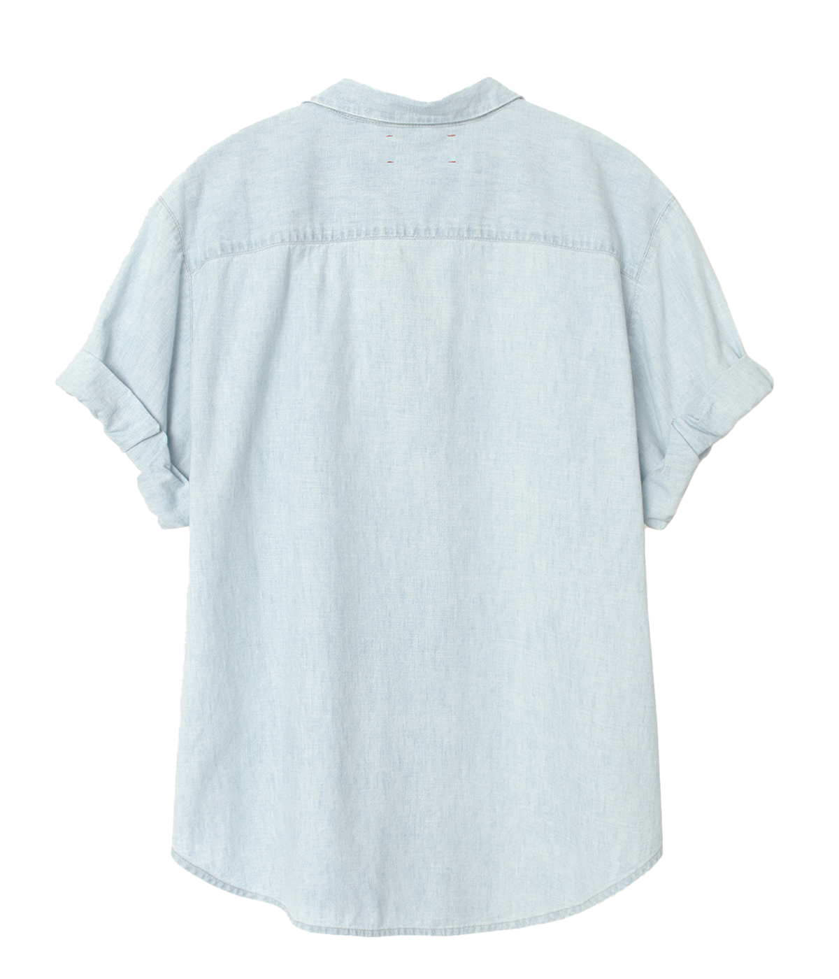 A light blue, slightly oversized shirt with a button-down front, made from soft cotton fabric. The shirt is styled casually, tucked into white trousers with rolled-up sleeves.