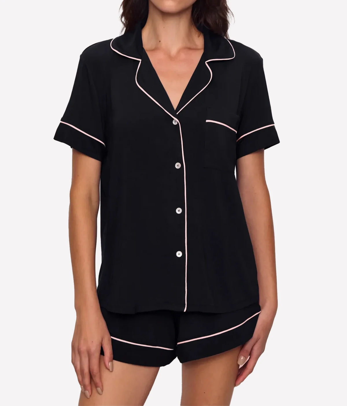 Model wearing the Eberjey Gisele Relaxed Short PJ Set In Black Sorbet Pink, front view showing the short sleeve button-up top with notch collar, chest pocket and sorbet pink piping, with matching shorts