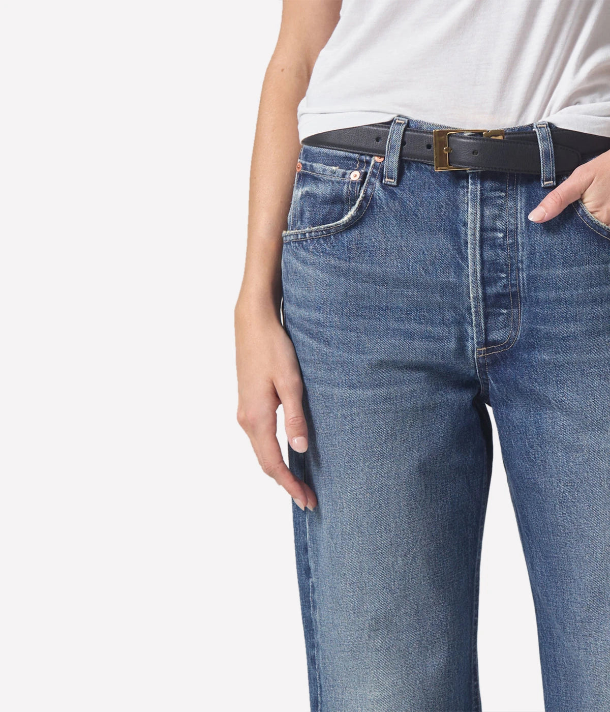 ALT Text: Relaxed vintage tapered jeans in a light indigo wash, styled with a low-rise fit and baby rolled cuffs.