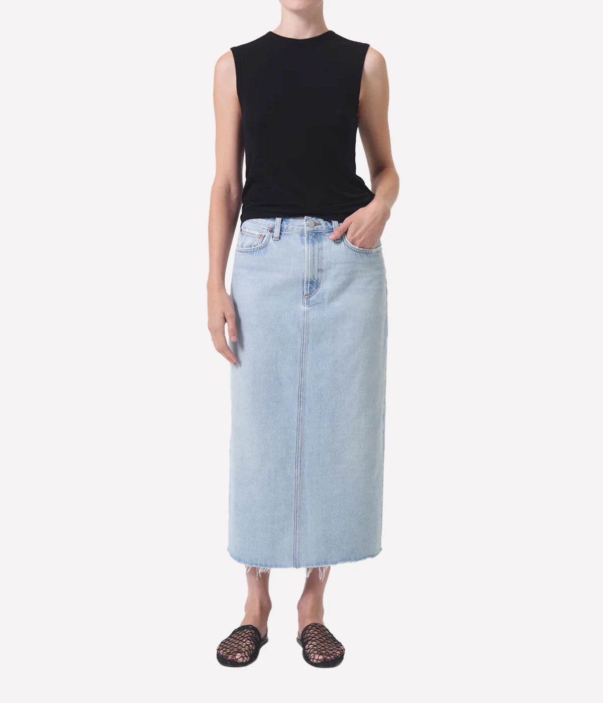 ALT Text: Della Skirt in light-washed indigo denim with raw hem, designed for ankle-grazing length and modern style.