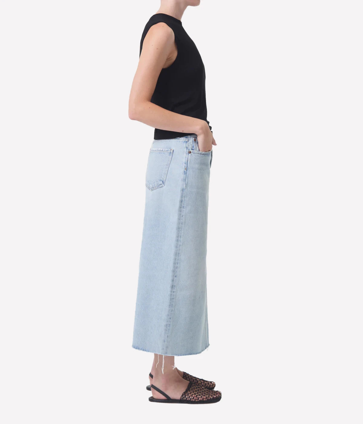 ALT Text: Della Skirt in light-washed indigo denim with raw hem, designed for ankle-grazing length and modern style.