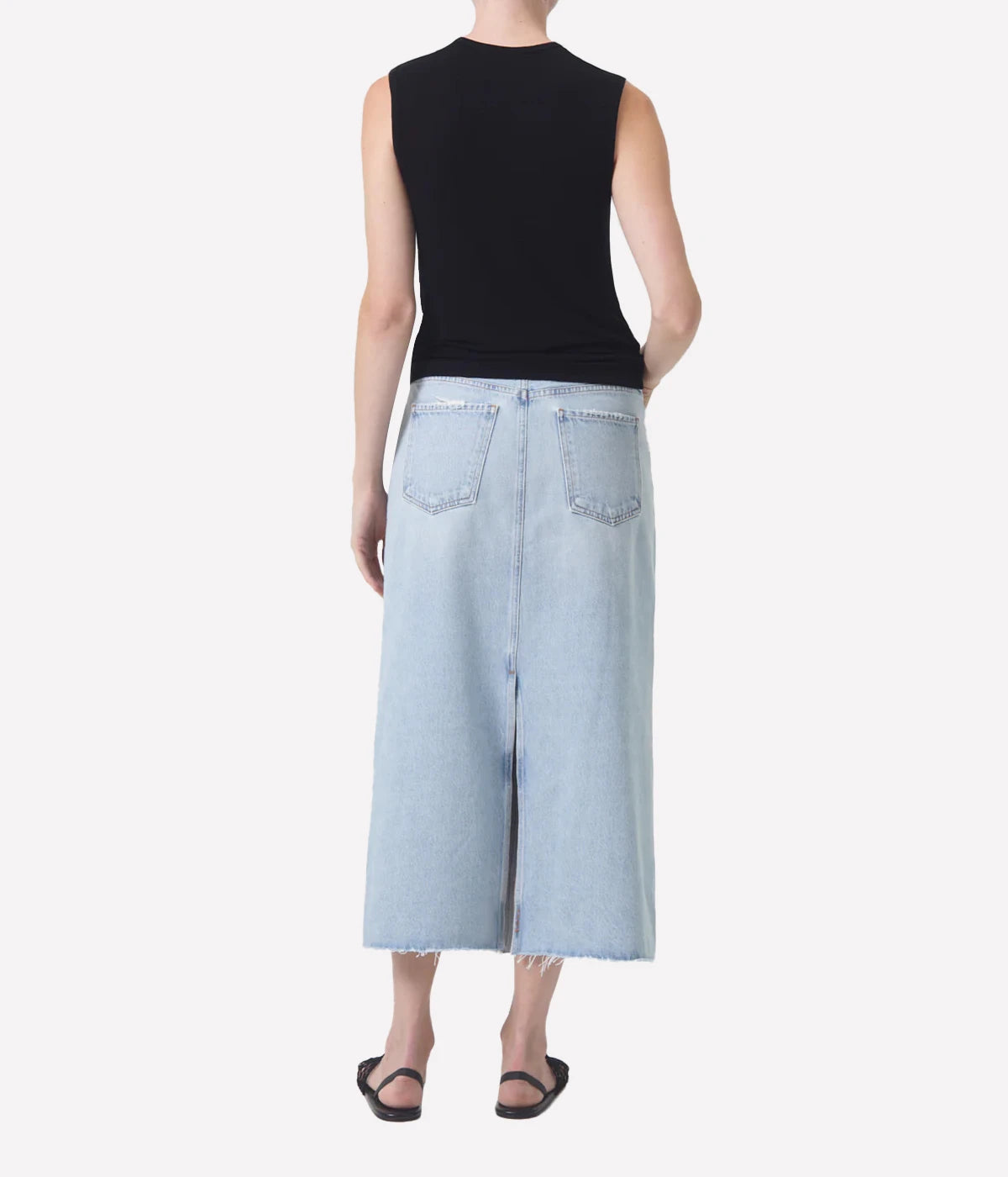 ALT Text: Della Skirt in light-washed indigo denim with raw hem, designed for ankle-grazing length and modern style.