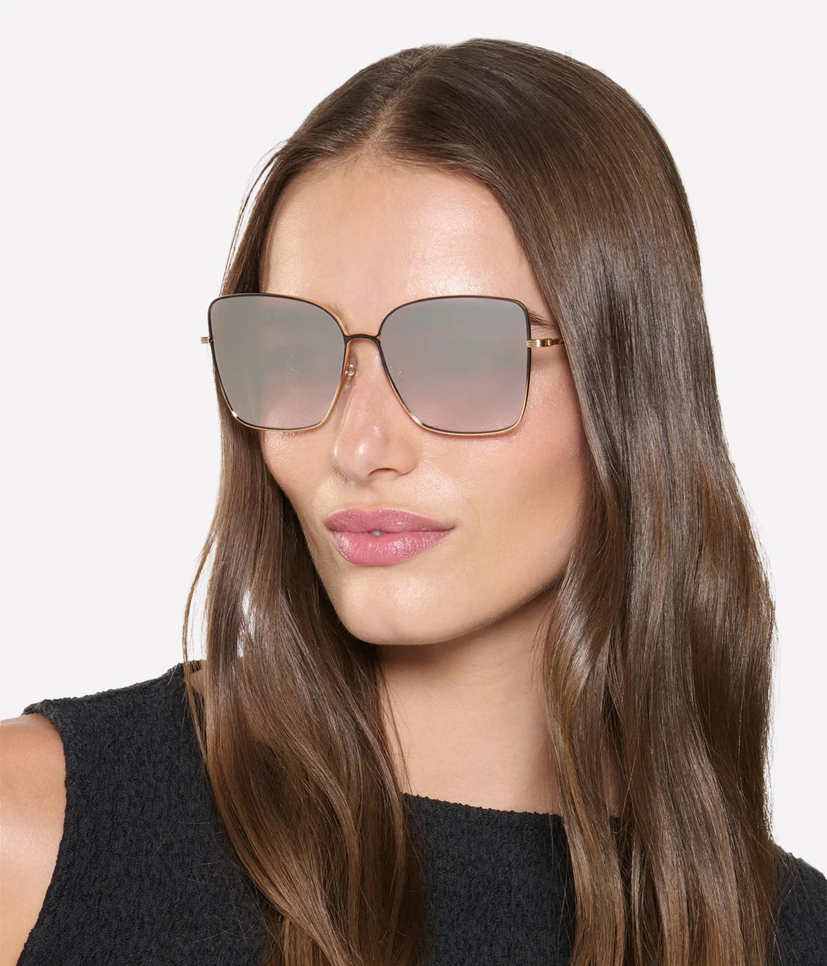 Model with long brown hair wearing the KREWE Dolly Sunglasses in Matte Black Fade with a black top, front view