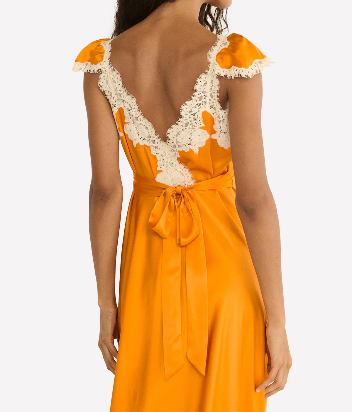 DÔEN Fiona Dress in Tangerine, close-up highlighting the plunging neckline and floral lace trim.