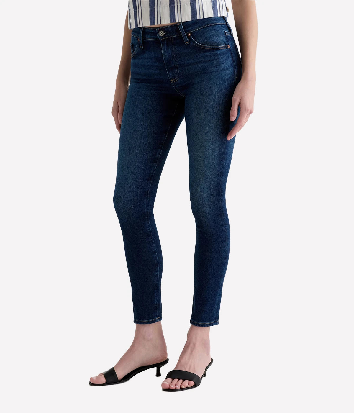 Person wearing dark blue jeans on a white background